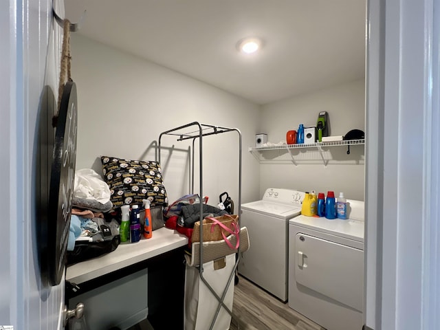 laundry room featuring light hardwood / wood-style floors and washing machine and clothes dryer