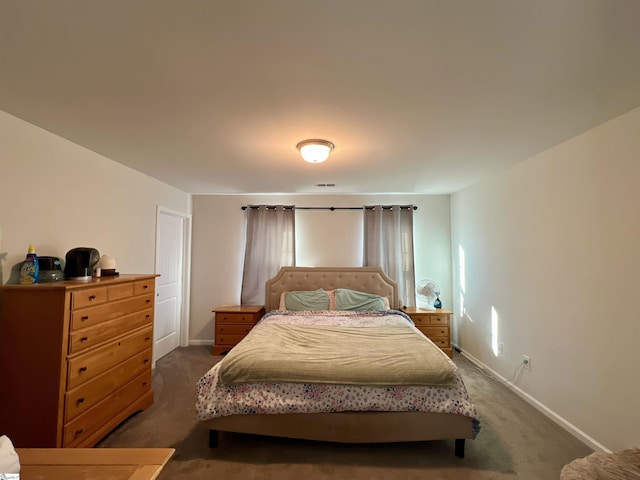 bedroom with dark colored carpet