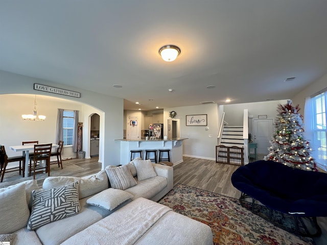 living room with wood-type flooring and an inviting chandelier