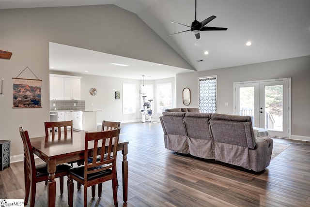 dining area with hardwood / wood-style floors, french doors, high vaulted ceiling, and ceiling fan