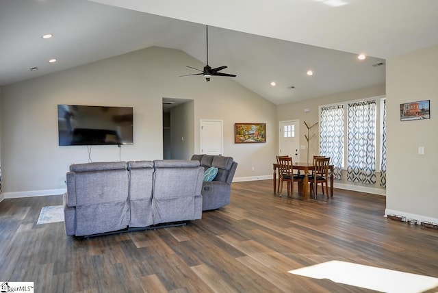 living room with dark hardwood / wood-style floors, ceiling fan, and high vaulted ceiling