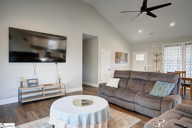 living room with ceiling fan, dark wood-type flooring, and high vaulted ceiling