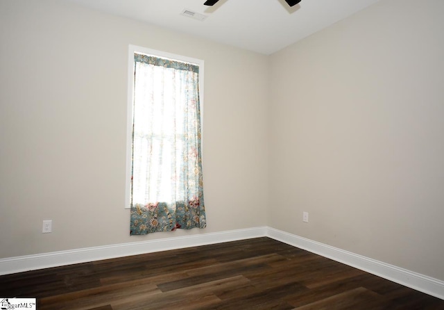 spare room with ceiling fan and dark hardwood / wood-style flooring