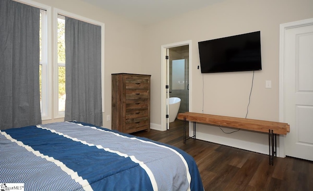 bedroom with dark wood-type flooring and ensuite bath