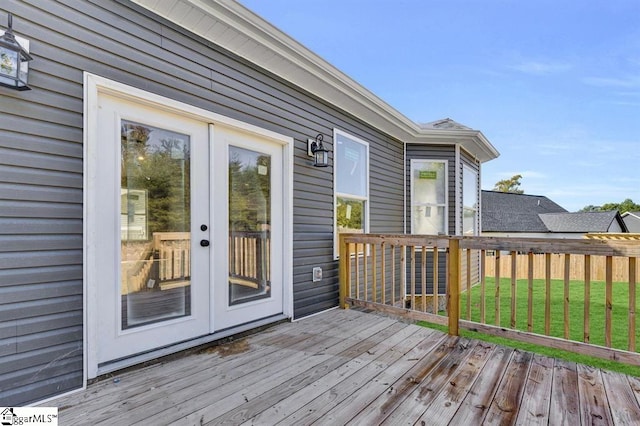 wooden terrace with french doors and a lawn