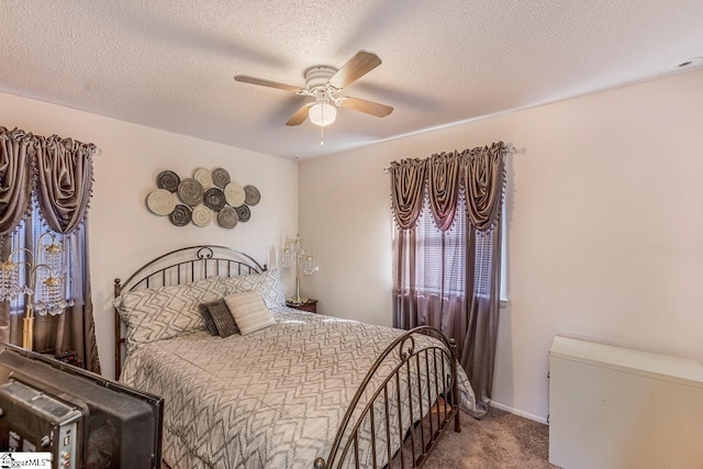 carpeted bedroom with ceiling fan and a textured ceiling