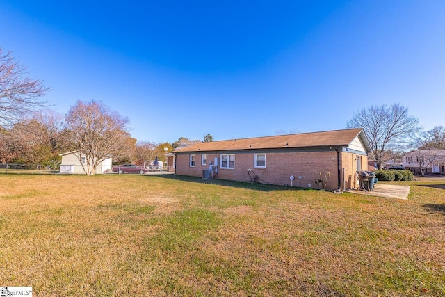 rear view of house featuring a lawn