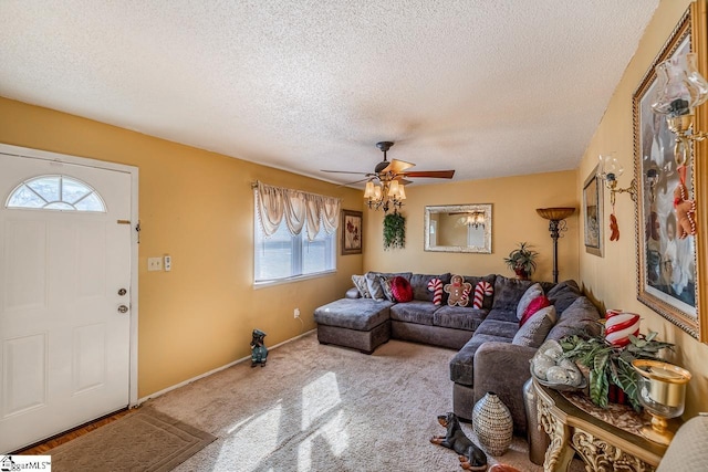 carpeted living room with plenty of natural light, ceiling fan, and a textured ceiling