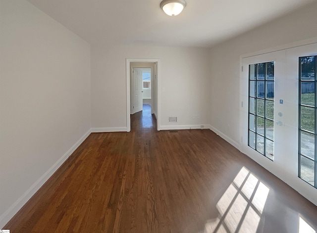 unfurnished room with dark hardwood / wood-style flooring