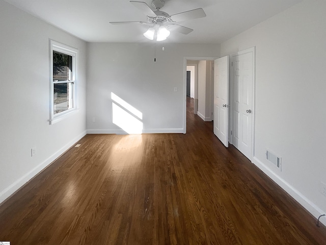 spare room with ceiling fan and dark hardwood / wood-style flooring