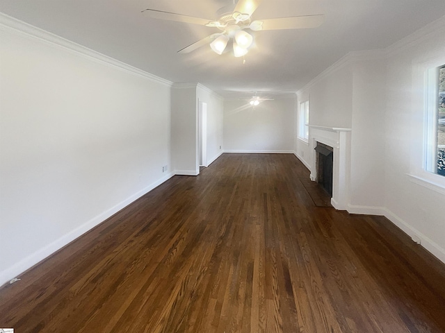 unfurnished living room featuring plenty of natural light, crown molding, and dark wood-type flooring