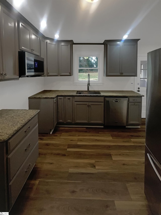 137 Batesview Dr, Greenville, SC 29607 - kitchen with appliances with stainless steel finishes, dark wood-style flooring, gray cabinets, and light stone countertops