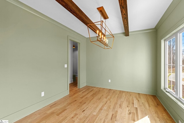 unfurnished room featuring beamed ceiling, light wood-type flooring, a chandelier, and a wealth of natural light