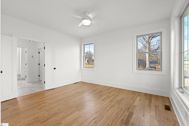 empty room featuring ceiling fan and light wood-type flooring