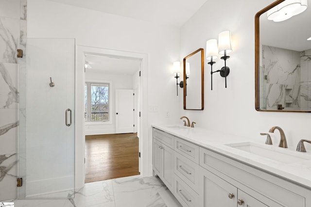 bathroom with hardwood / wood-style floors, vanity, and a shower with door