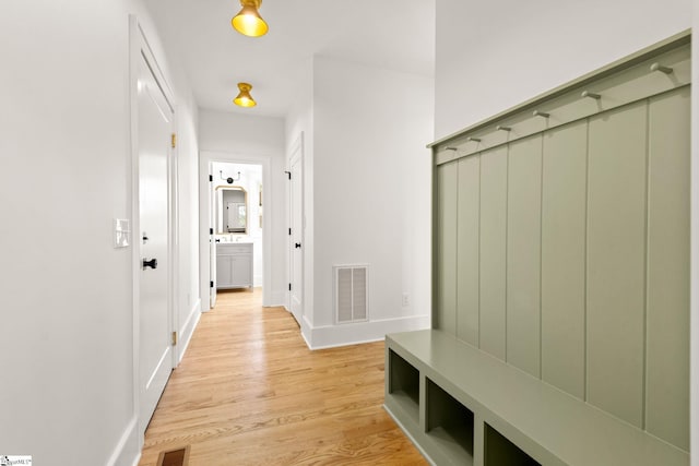 mudroom with light hardwood / wood-style flooring