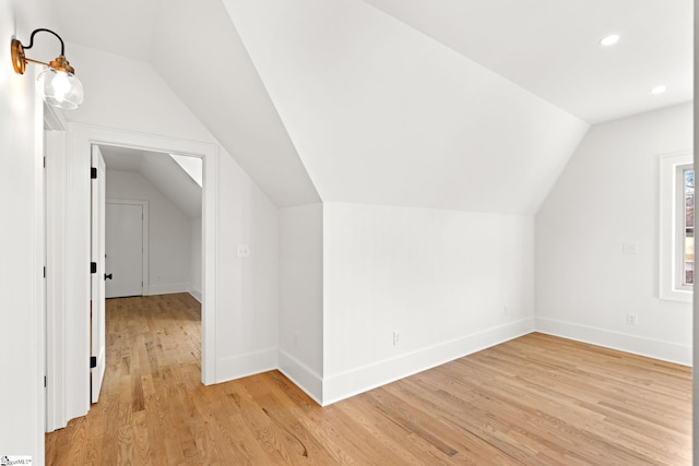 bonus room featuring light wood-type flooring and lofted ceiling