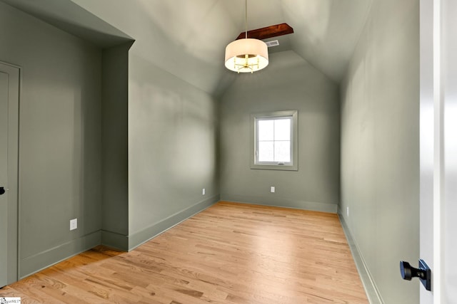 unfurnished room featuring light hardwood / wood-style floors and lofted ceiling