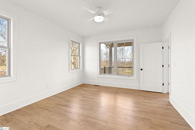 empty room featuring a healthy amount of sunlight and light hardwood / wood-style flooring