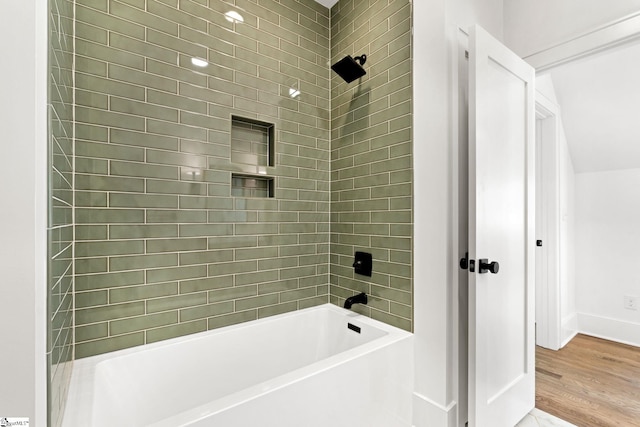 bathroom featuring hardwood / wood-style floors and tiled shower / bath