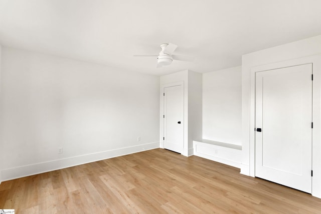 empty room with ceiling fan and light wood-type flooring