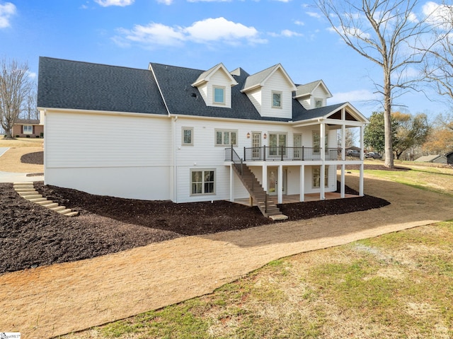 rear view of property featuring a patio area and a deck