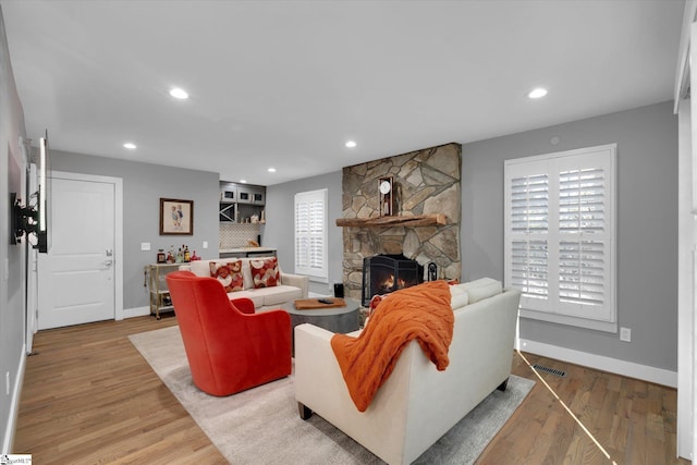 living room featuring a fireplace and light wood-type flooring