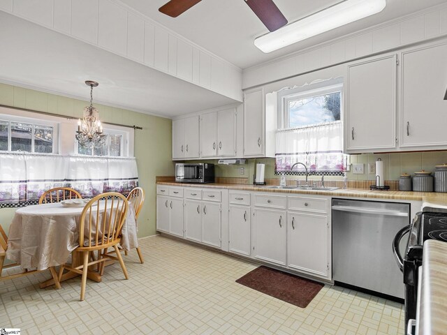 kitchen with white cabinetry, ornamental molding, hanging light fixtures, and appliances with stainless steel finishes