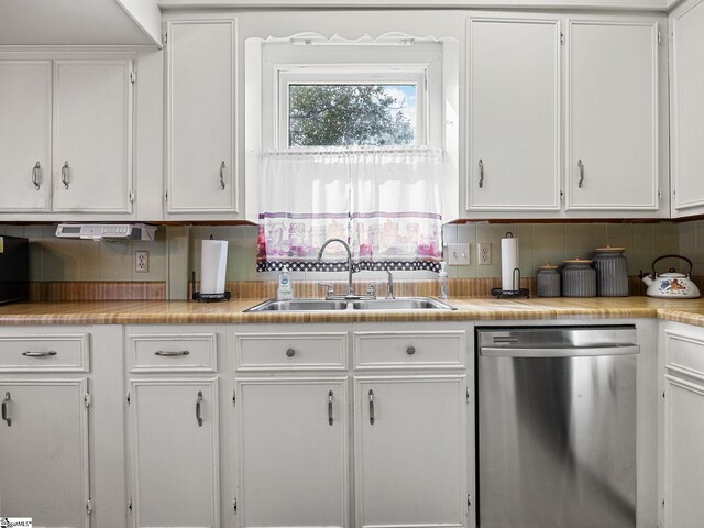 kitchen with decorative backsplash, white cabinetry, dishwasher, and sink