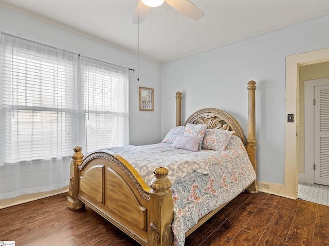 bedroom featuring ceiling fan, crown molding, and dark hardwood / wood-style floors