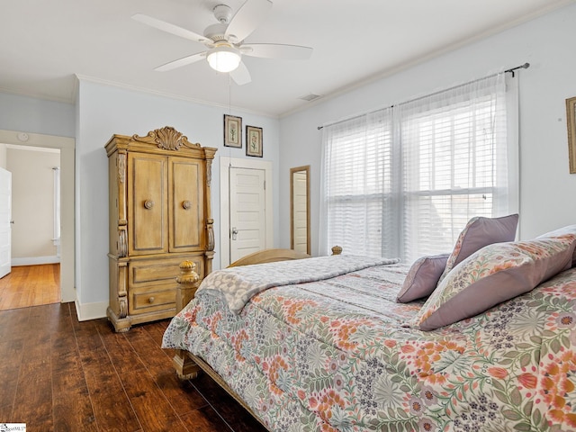 bedroom with ceiling fan, crown molding, and dark wood-type flooring