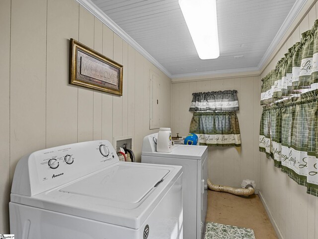 laundry area featuring carpet flooring, wooden walls, ornamental molding, and washing machine and clothes dryer