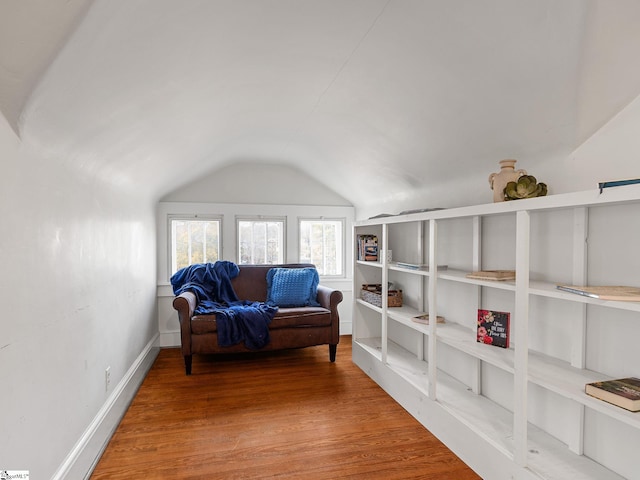 sitting room featuring wood-type flooring and vaulted ceiling