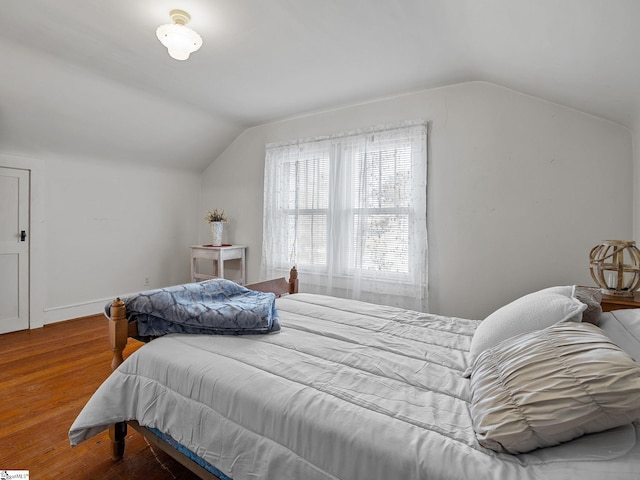 bedroom featuring hardwood / wood-style flooring and vaulted ceiling