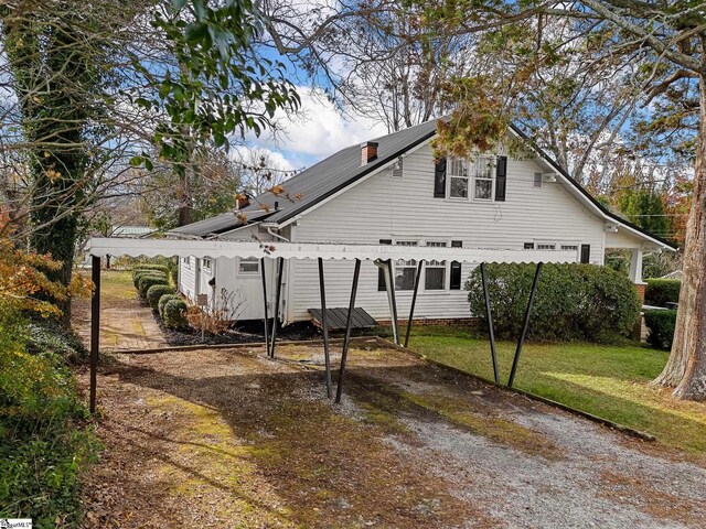 rear view of property featuring a lawn