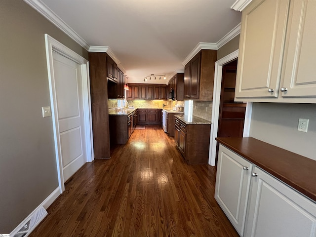 kitchen featuring backsplash, stainless steel range oven, ornamental molding, dark hardwood / wood-style flooring, and dark brown cabinetry