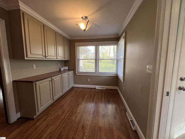 clothes washing area with dark hardwood / wood-style floors and ornamental molding