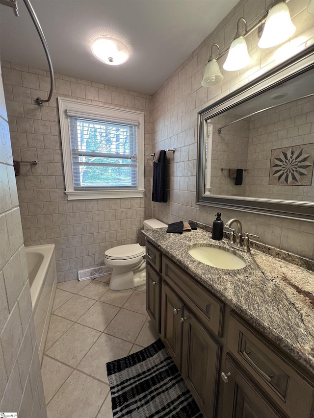 full bathroom featuring tile patterned floors, toilet, shower / washtub combination, vanity, and tile walls