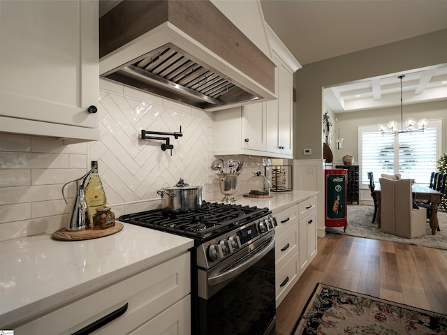 kitchen featuring custom exhaust hood, white cabinetry, dark hardwood / wood-style flooring, and stainless steel range with gas cooktop