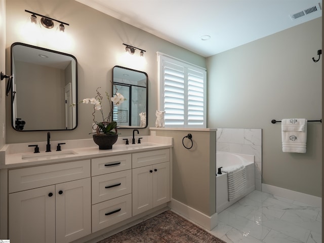 bathroom featuring a tub to relax in and vanity