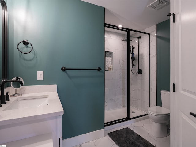 bathroom featuring tile patterned floors, vanity, toilet, and an enclosed shower