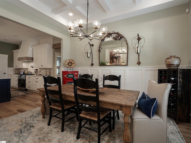 dining room with beam ceiling, hardwood / wood-style floors, coffered ceiling, and a notable chandelier