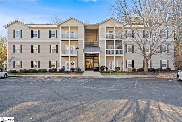 view of building exterior featuring uncovered parking