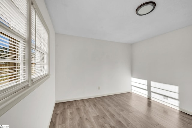 spare room with light hardwood / wood-style flooring