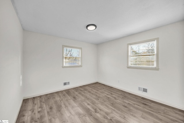 unfurnished room with light wood-type flooring