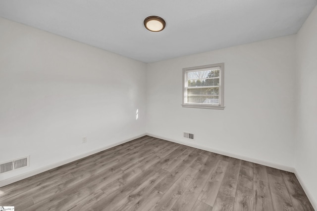 unfurnished room with light hardwood / wood-style flooring