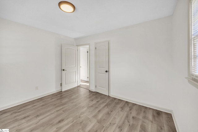 unfurnished room featuring light wood-type flooring