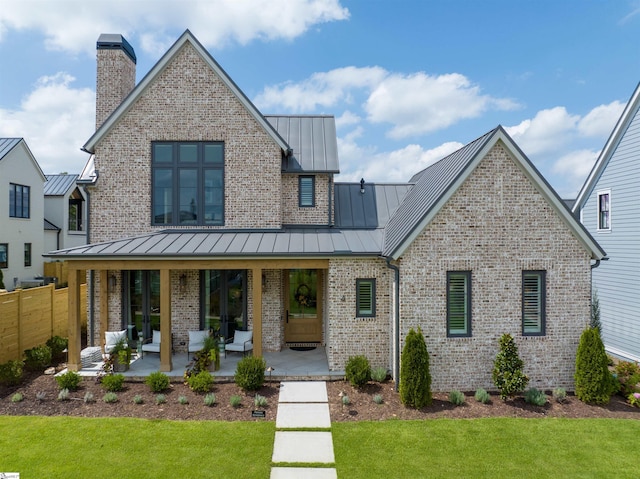 view of front of property with a front lawn and a patio area