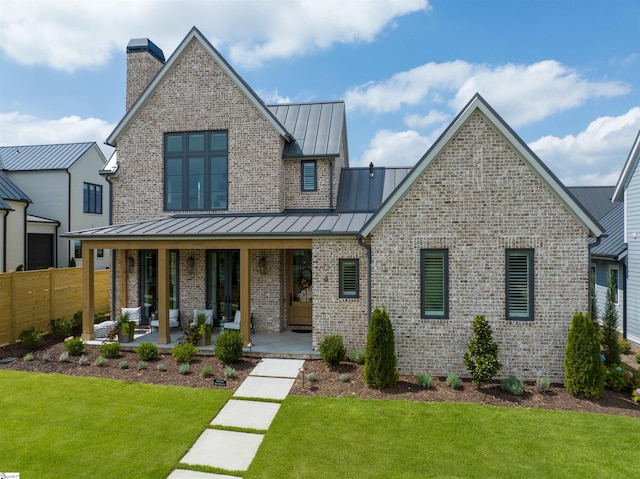 view of front of property featuring a front lawn and a porch