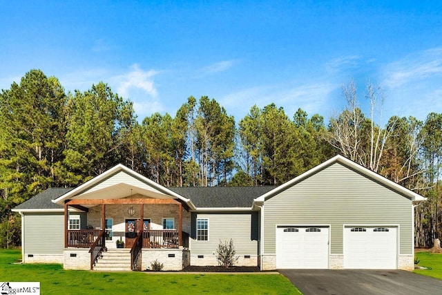 ranch-style house featuring a porch, a garage, and a front lawn